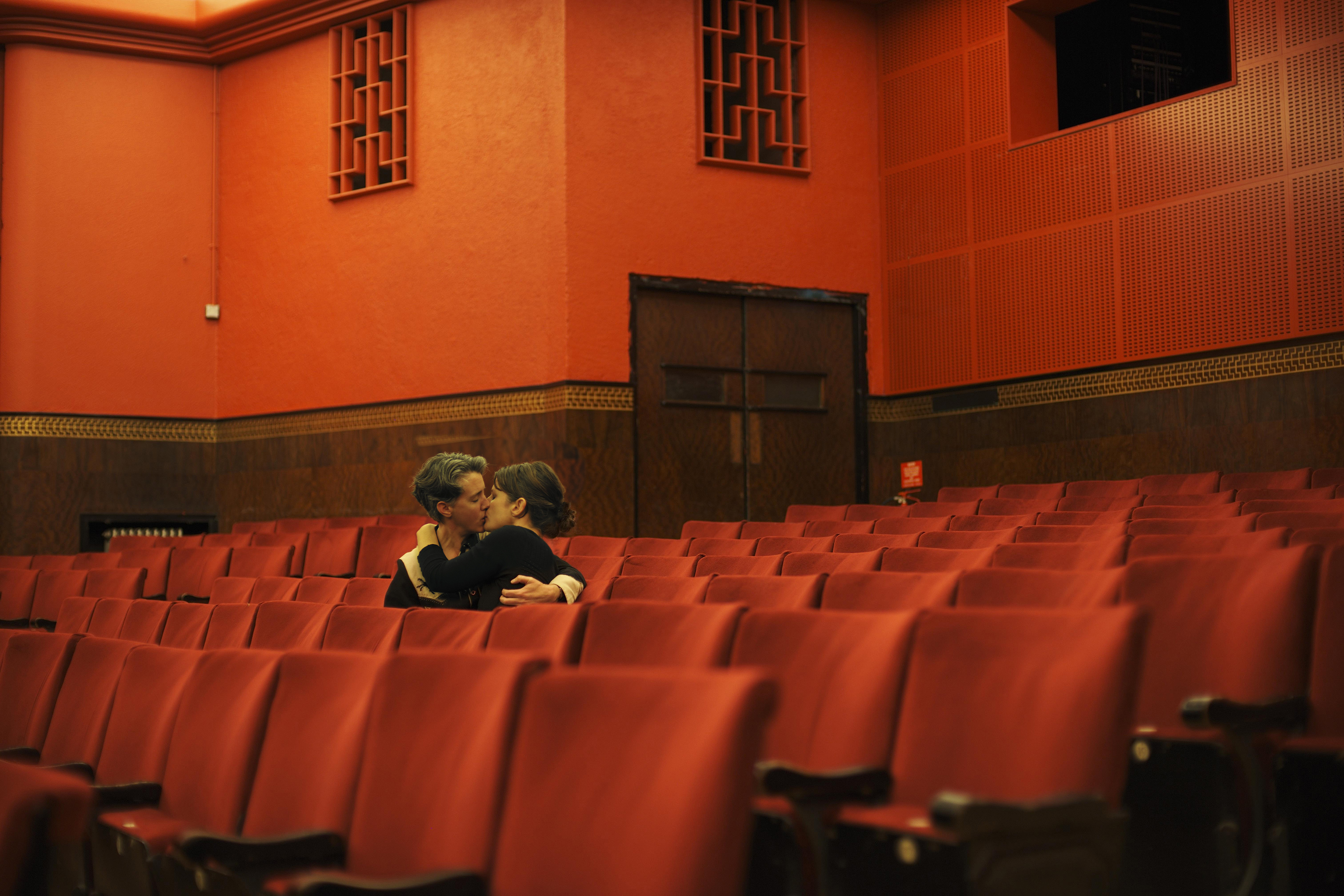 Couple kissing in an empty theatre