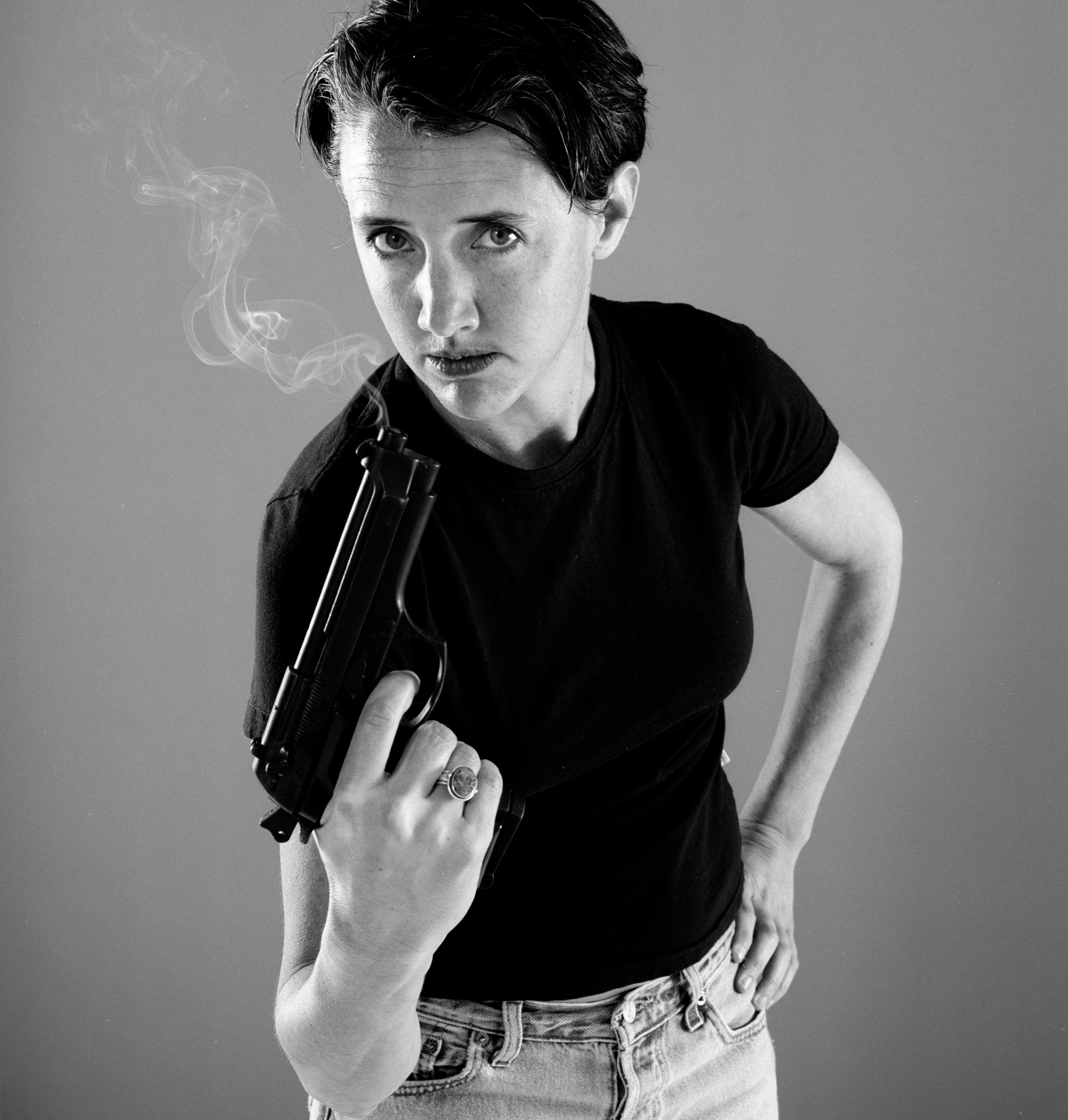 Woman holds smoking gun