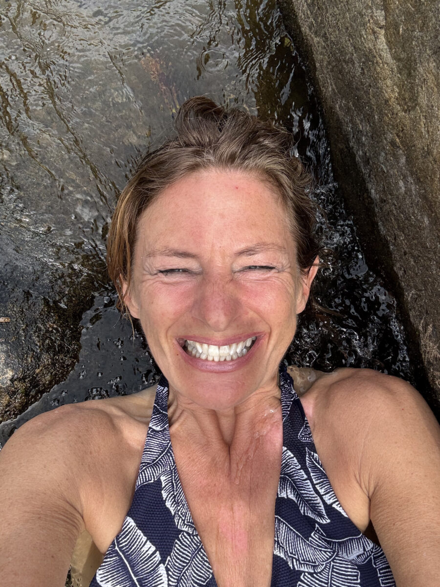 woman smiling in water with closed eyes